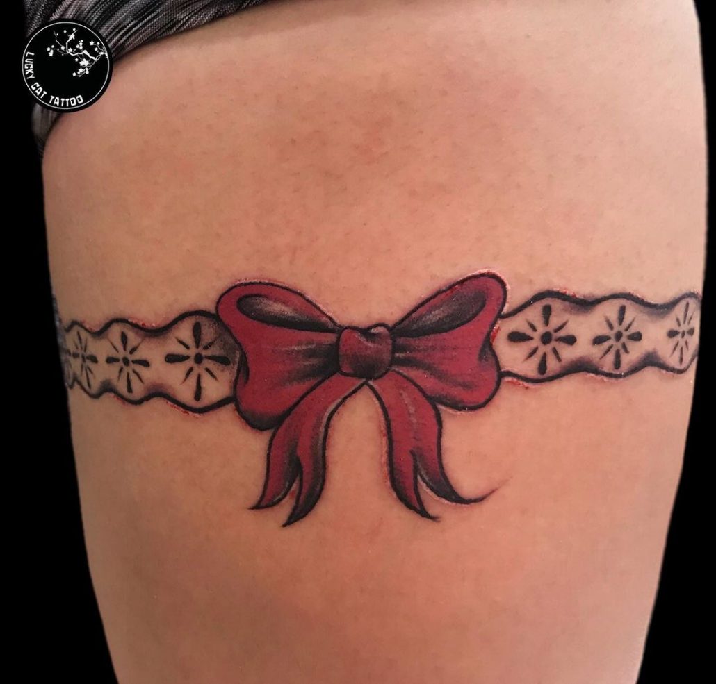 garter tattoo with a red bow