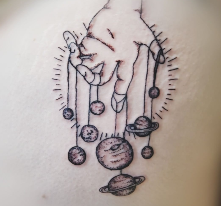 Amazing hand-holding planet tattoos